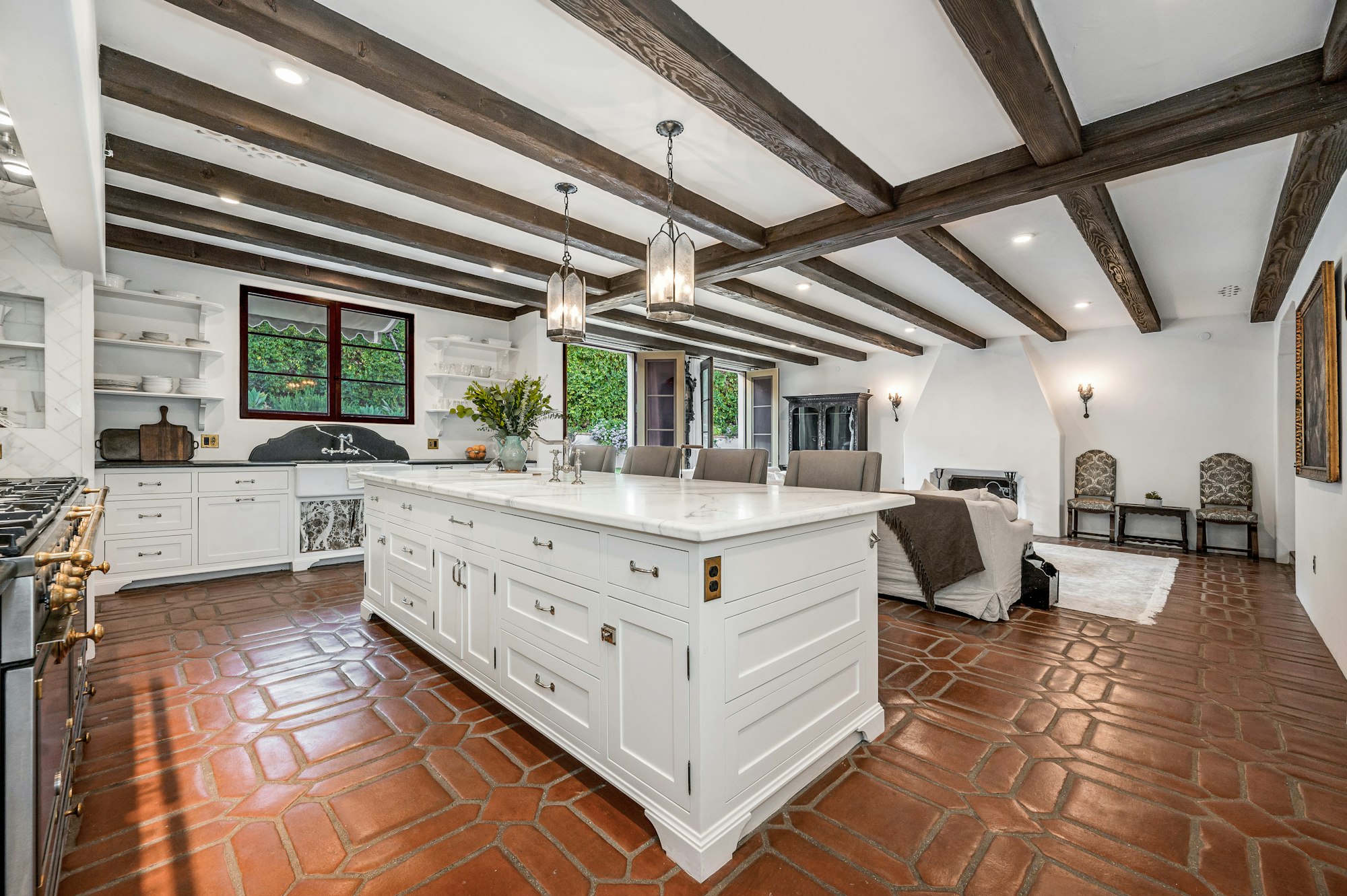 an open concept kitchen and living area in a house with exposed ceiling