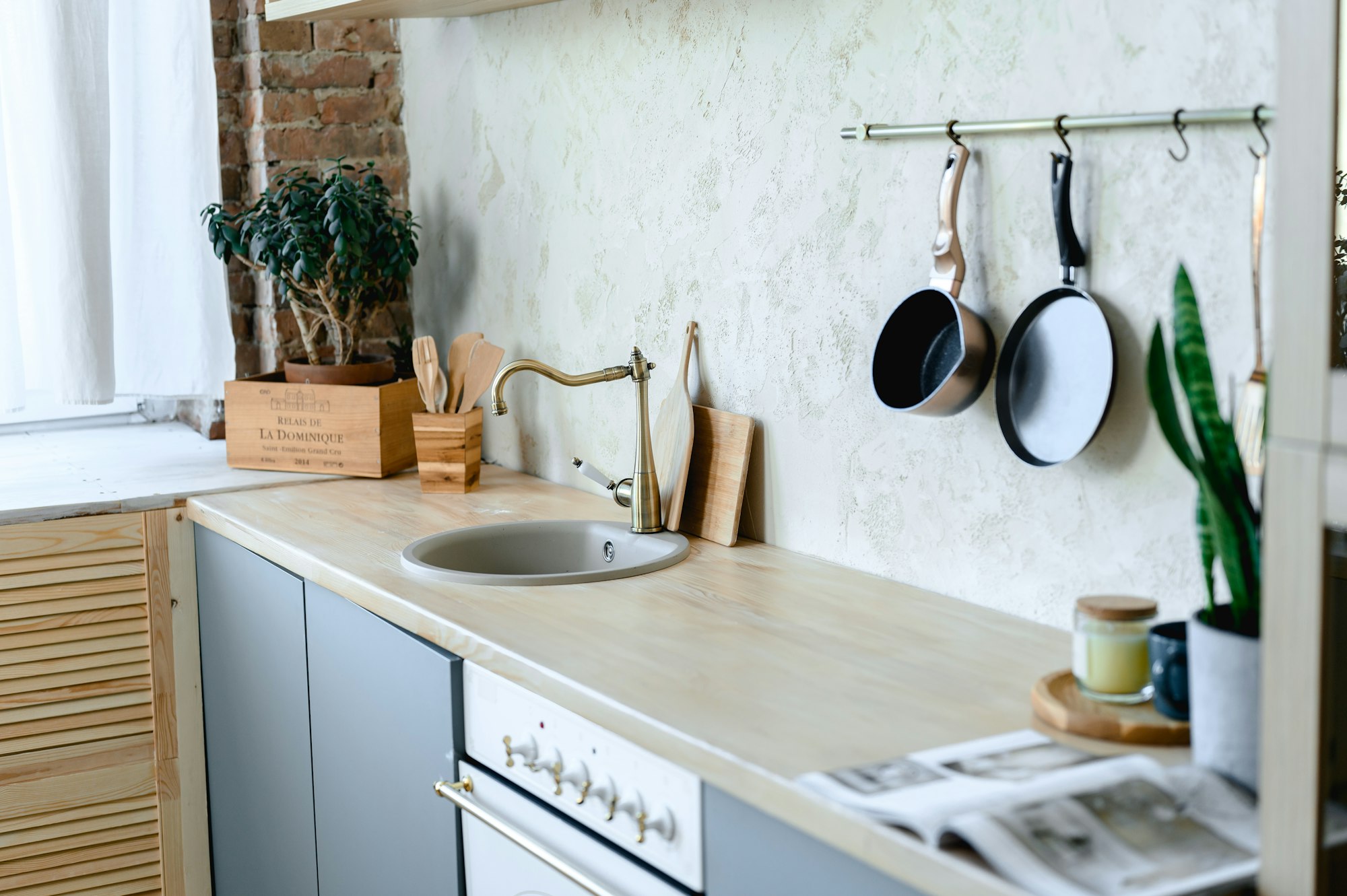 cozy kitchen interior in gray colors and wooden decor