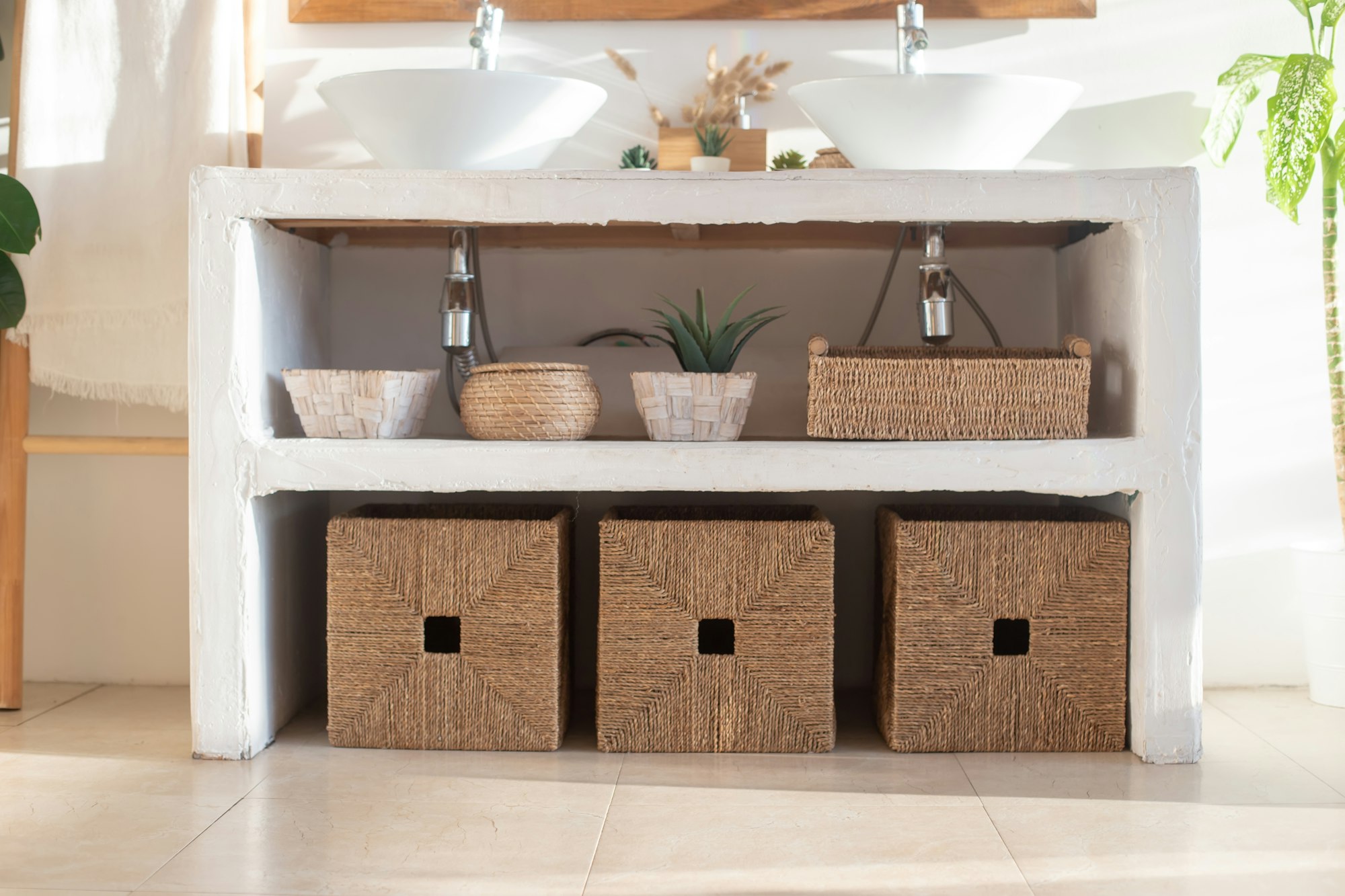 Details of modern cozy white interior bathroom with wicker boxes