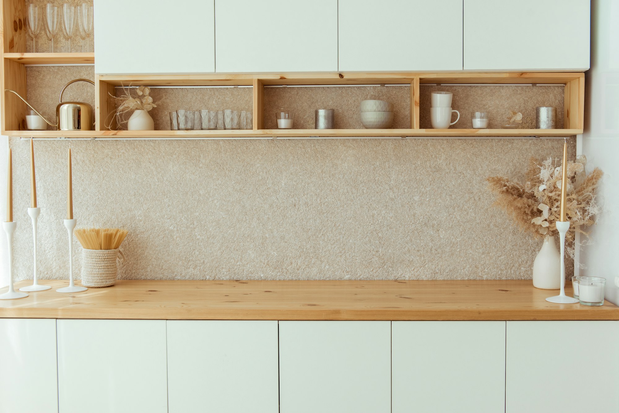 Kitchen shelves with various white ceramic, glass jars. Open shelves in the kitchen.