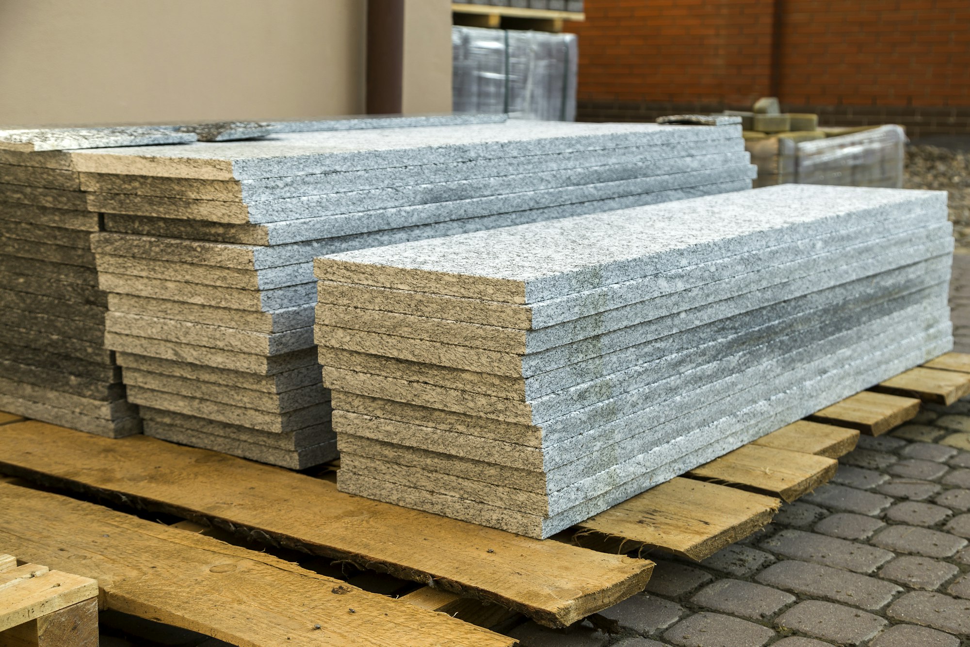 Piles of granite marble slabs. Stone sheets for decorative construction