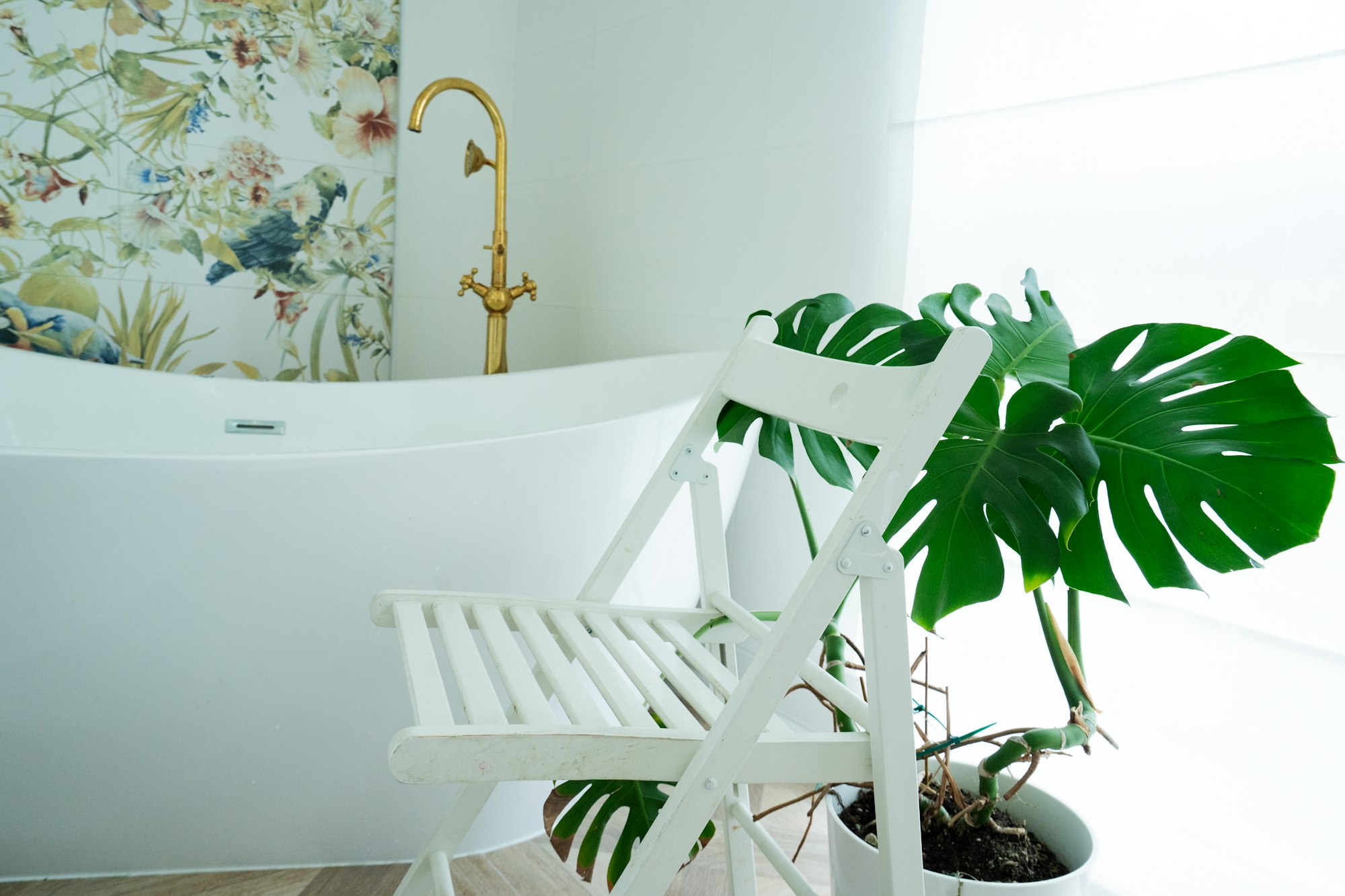 White bathroom with empty white chair