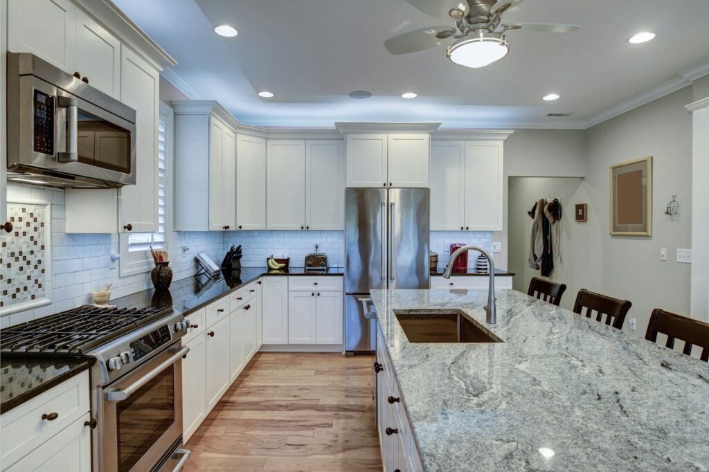 Beautiful luxury kitchen with quartz and granite countertops and white cabinets.