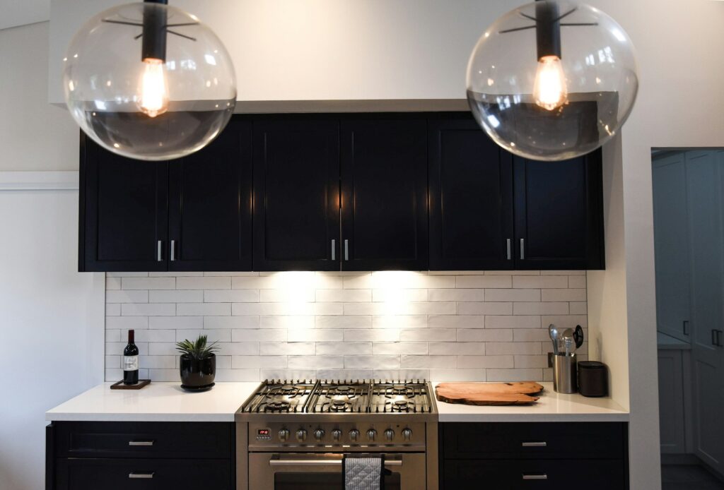 Kitchen decor. Contemporary lighting, subway tiles and a modern kitchen layout