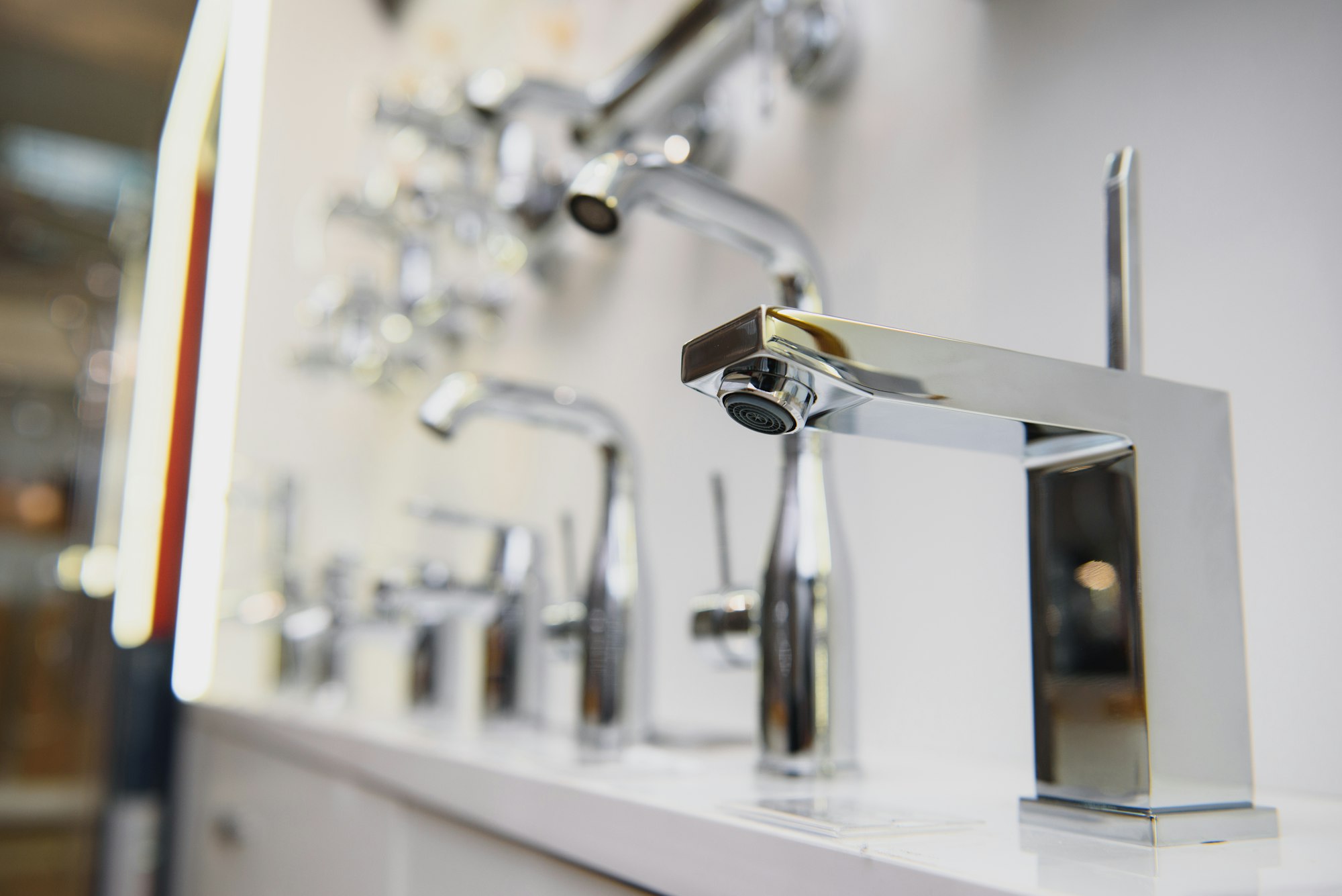 showcase in the store with faucets for the kitchen and bathroom