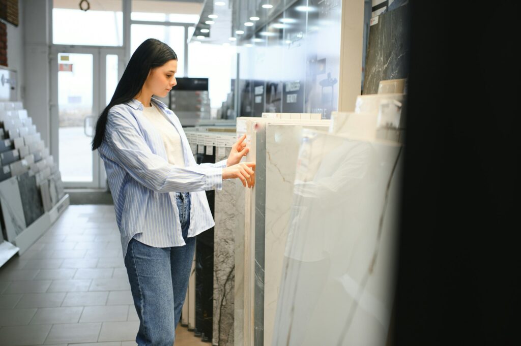 Young woman choosing ceramic tiles