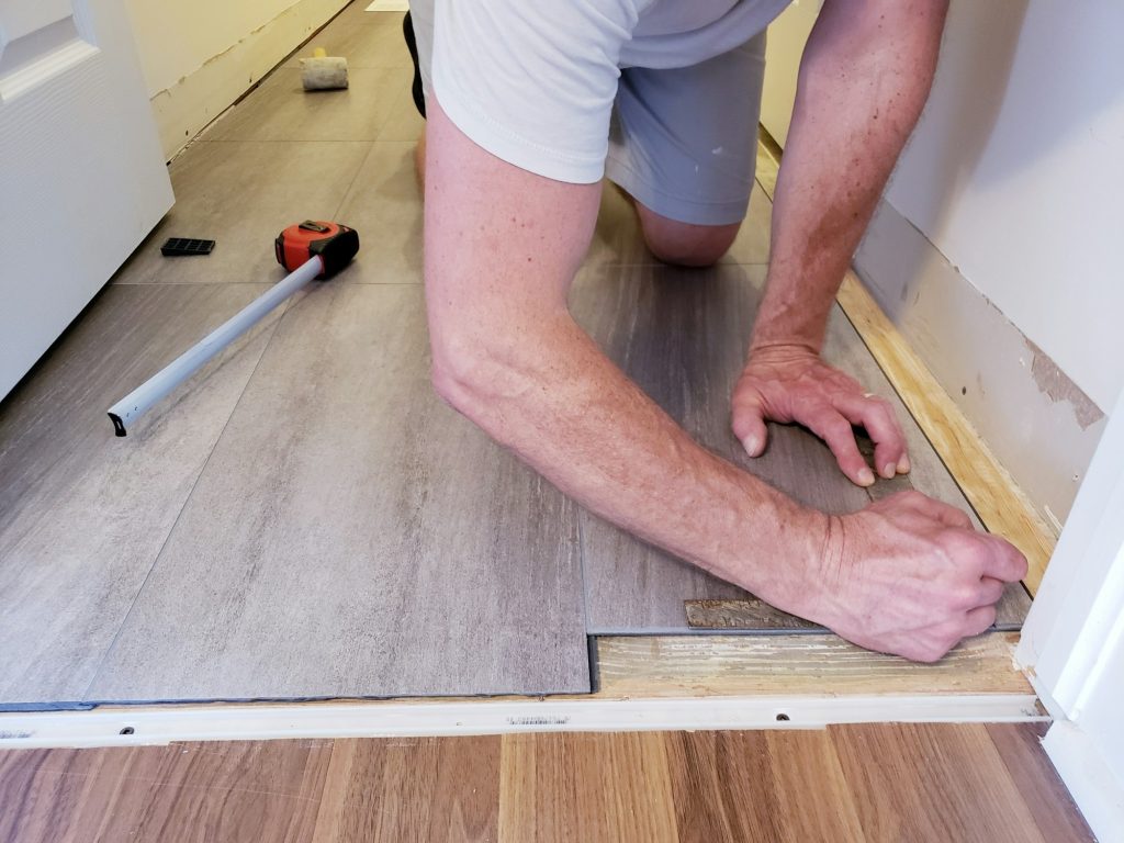 Floor level view of laminate flooring installation, home renovation, construction materials, tiles