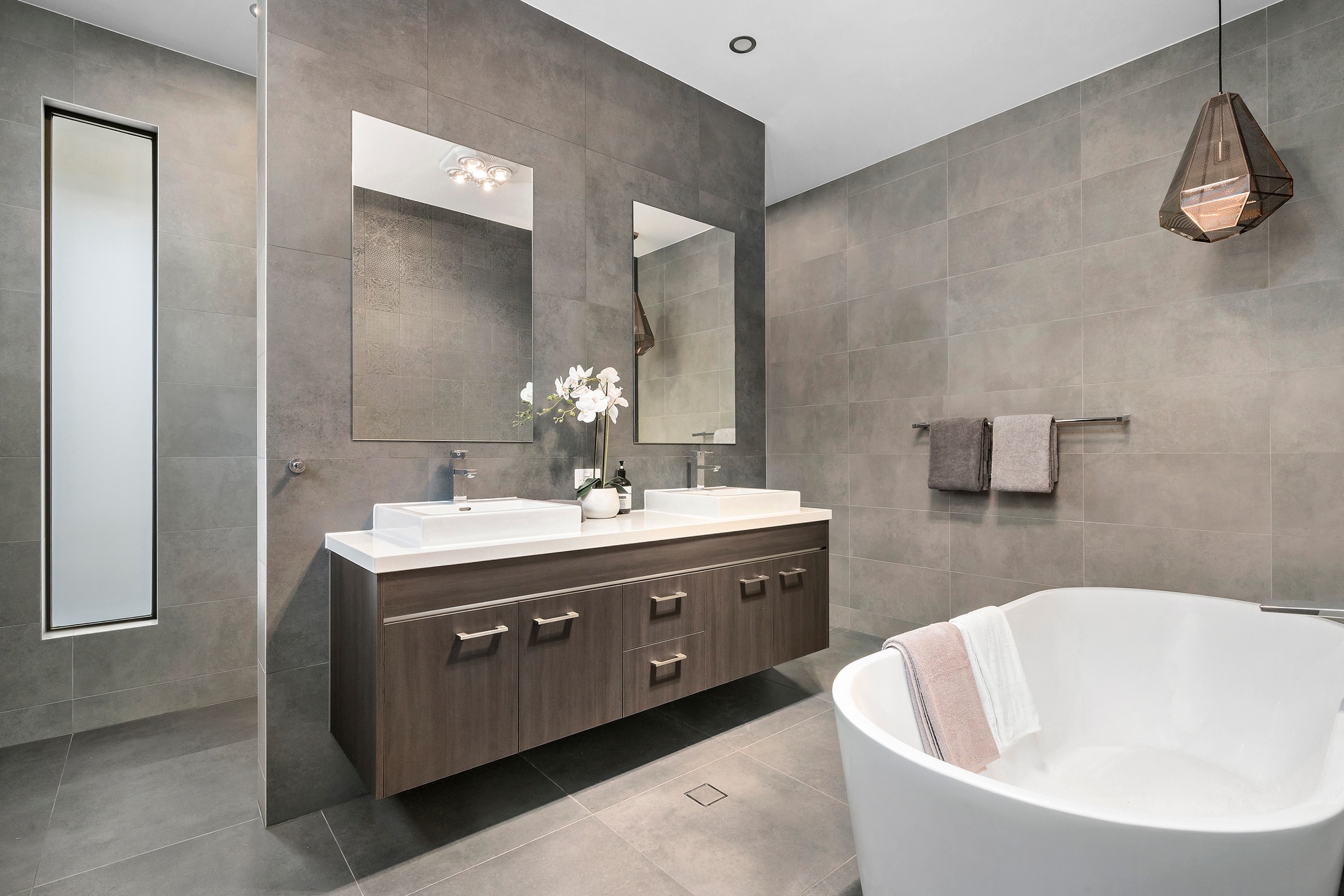 Sleek, contemporary home bathroom with white fixtures